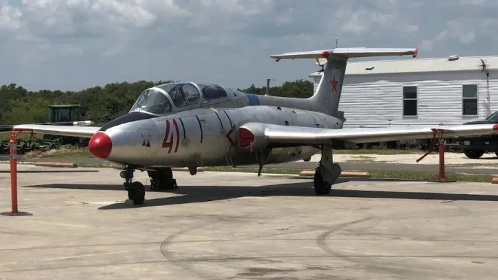 Front view of the L-29 Delfín on the tarmac under a Texas sky
